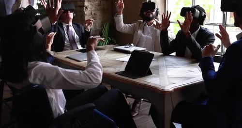 Business people wearing virtual reality goggles inside office