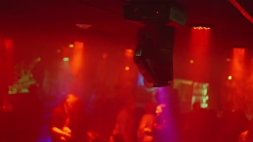 Nightclub Scene with Dancing People and Moving Lights