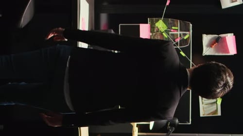 Man Standing in Office with Desk and Wall