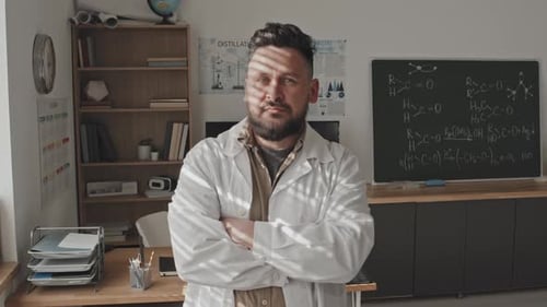 Bearded Scientist Standing in Front of Blackboard