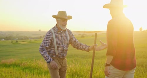 Handshake Full Length View of the Senior Farmer Greeting with Handshake with His Young Colleague