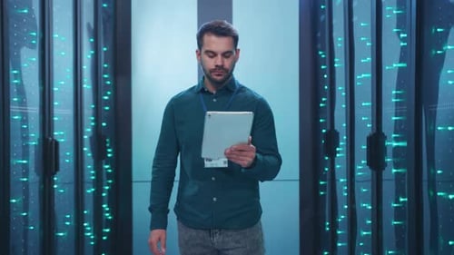 Man Using Tablet in Brightly Lit Server Room