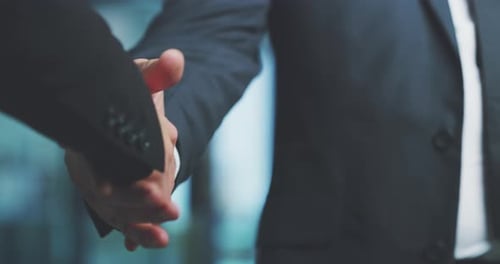 4k video footage of two unrecognizable businesspeople shaking hands in the office