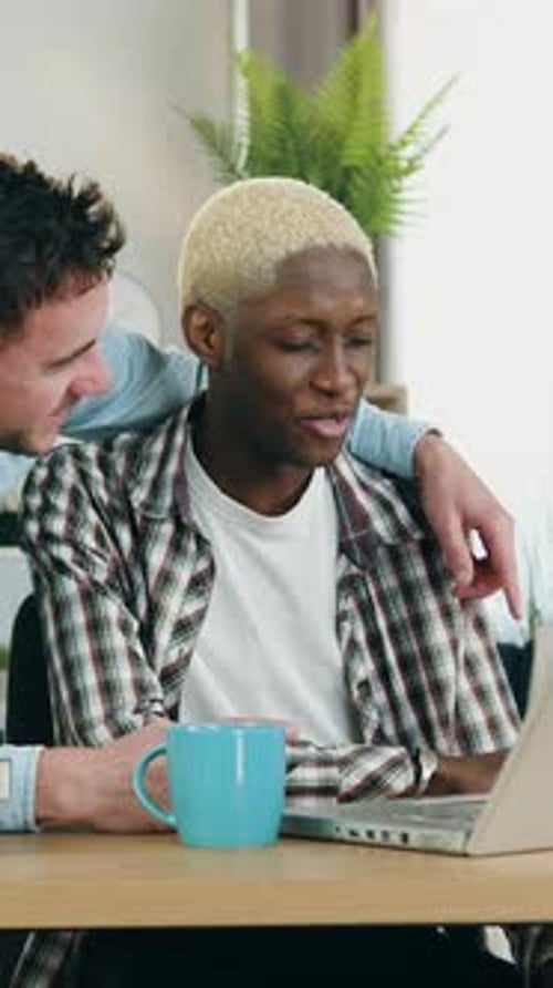 Young Couple Looking at a Laptop in an Apartment