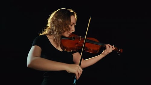 Woman Plays Violin in Studio Setting