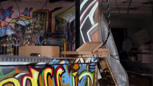 Close Up of Pizza Boxes Leftover By Teenagers in City Suburb Abandoned Building