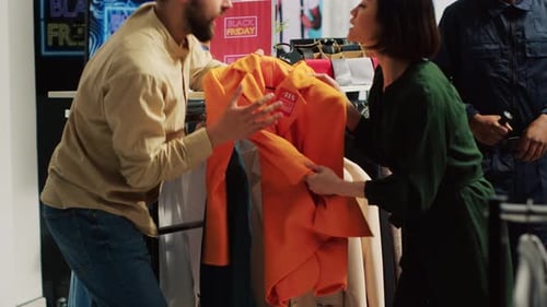 Adults Fighting Over Clothing During Black Friday Sale