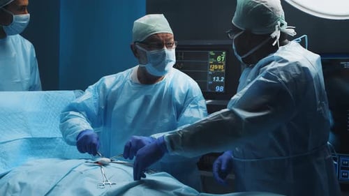 Multiracial Team of Professional Medical Surgeons Performs the Surgical Operation in a Modern