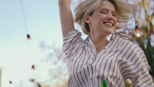 Young Adults Celebrating Outside With Beer