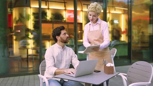Waiter and Customer at Cafe