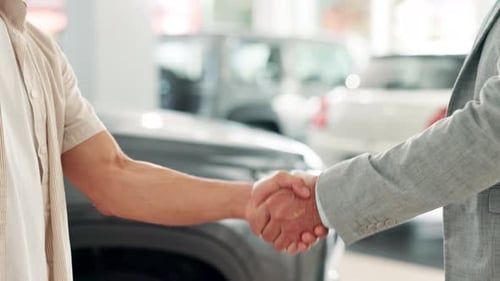 Handshake, man and dealership for car with keys, salesman and customer for successful purchase