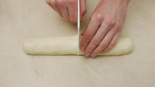 Cutting Fresh Dough on a Countertop
