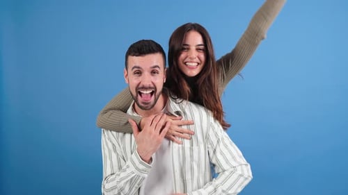Happy Couple Embracing and Smiling in Studio