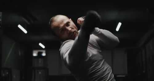 Athletic Man in Boxing Stand on a Dark Background