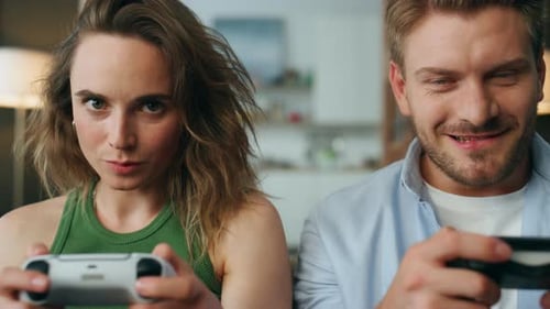 Young Couple Enjoys Playing Video Game Together Indoors