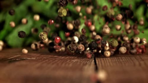 Spices falling onto a wooden table close up