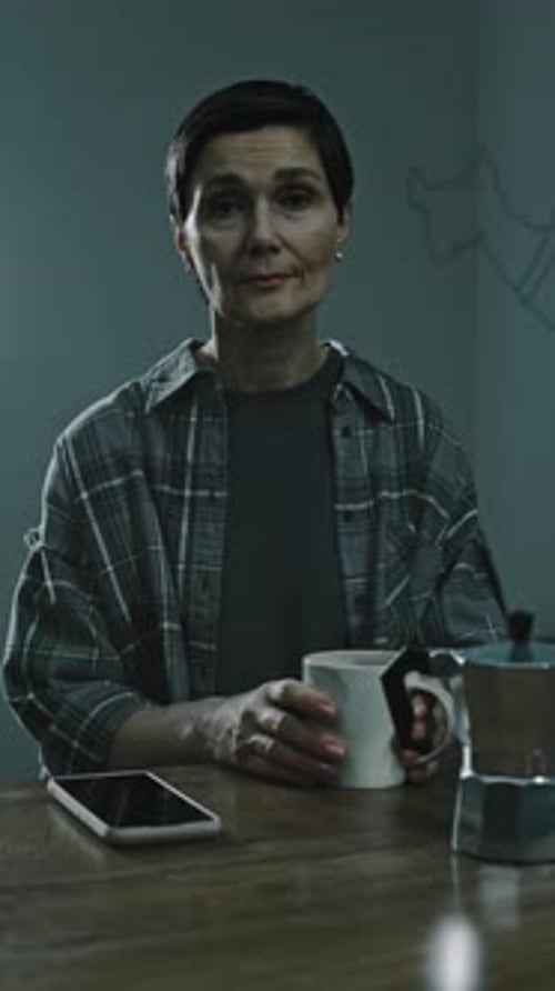 Woman Sitting with Coffee Mug at Night