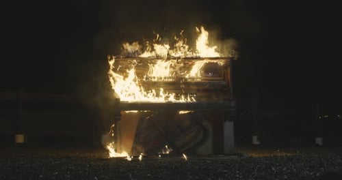 Piano Engulfed in Flames at Night