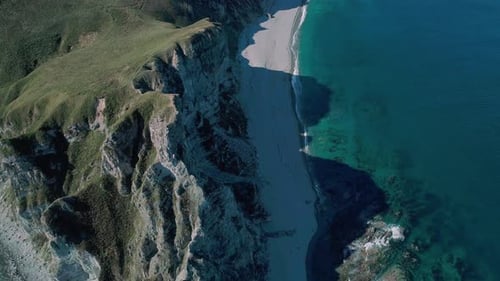 Aerial Panoramic View of the Rocky Cliffs Seaside and Waves are Crashing to the Coast Beautiful