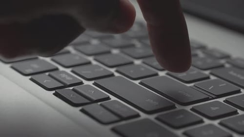 Finger Tapping Enter Key on Laptop Keyboard