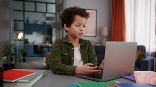 Boy Using Laptop for Online Education at Home
