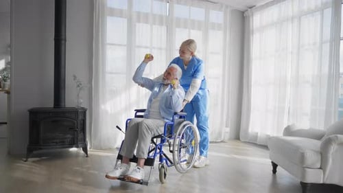 Senior Man Doing Arm Exercises with Assistant
