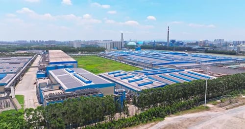 Aerial View of Modern Factory Solar Panels
