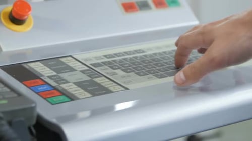 Hand Operating Touch Screen Control Panel on Machine