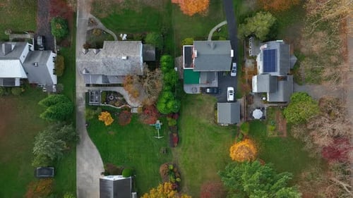 Top down aerial of mansions in American suburbs during autumn. Rooftop birds eye view.
