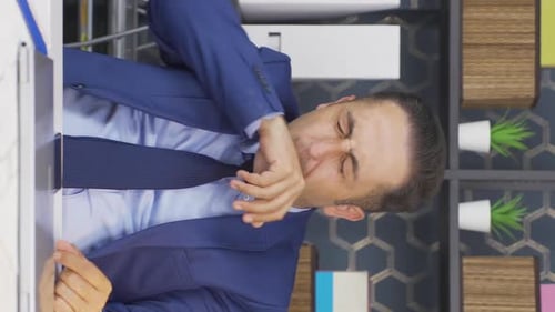 Exhausted Office Worker Yawns at His Desk