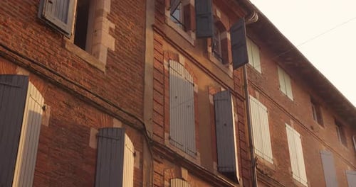 Red Brick Architecture And Window Shutters In Old Town Of Albi At Dusk In France. - wide shot