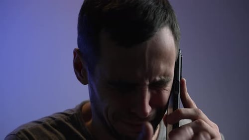 Distressed Man Cries While Talking on Cell Phone