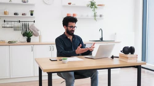 Consultant Receiving Video Call Via Computer in Home Office