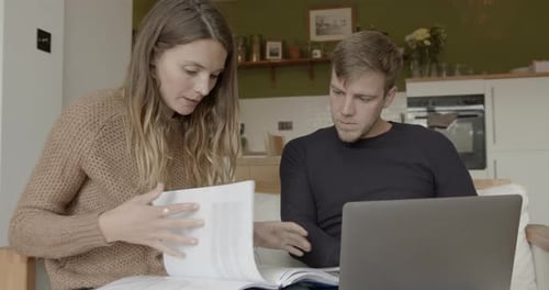 Woman and Man Working on Laptop at Home