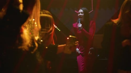 Stylish Woman Performing on Stage at Nightclub