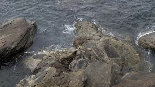 A rocky coast with a tidal waves hitting the rocks continuously