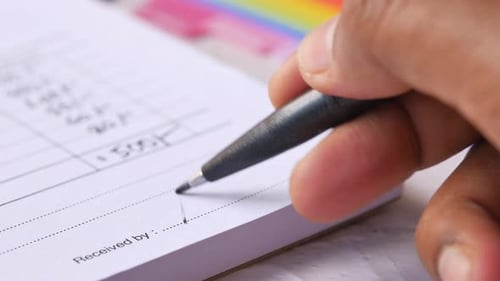 Person Signing Document with Pen Close Up
