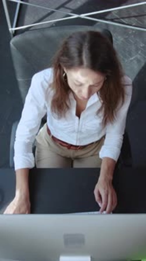Young Woman Crossing Fingers at Computer
