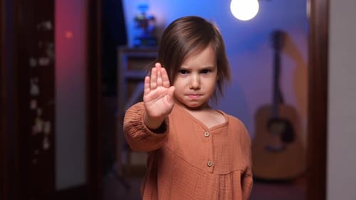Child With Hand Up in Stop Gesture