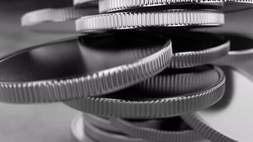 Donations in games. Falling stacks of coins in a row, coins on a metal table.