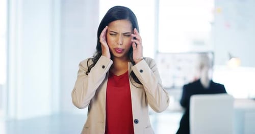 Woman Suffering Headache in Bright Office Setting