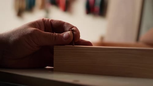 Carpenter Sinks Screws Into Wooden Surfaces with Power Drill Close Up