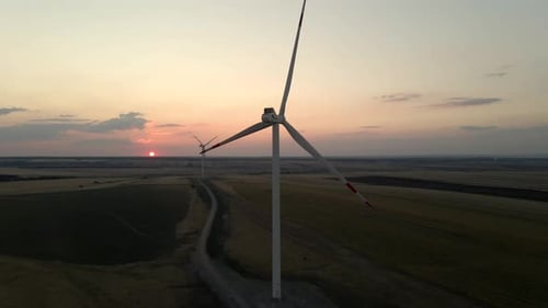 Exploring Windmills in a Sunset Landscape at a Windmill Park Showcasing Renewable Energy and