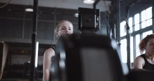 Active and Healthy Lifestyle Young Beautiful Happy Blonde Woman Working Out on Rowing Machine in Gym