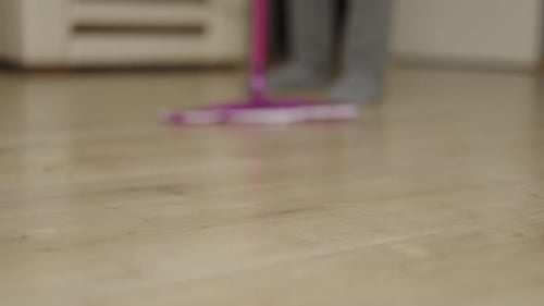 Pink Mop Cleaning Wood Floor at Home