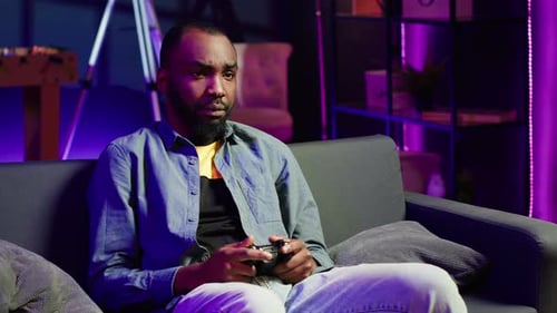 Young Man Playing Video Games on Couch