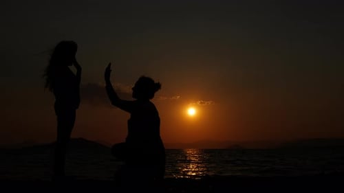 Happy Child with Mom on the Evening Beach