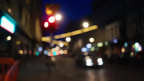 A Picturesque Nighttime City Street Scene Featuring Blurred Traffic Lights and a Captivating Ambient
