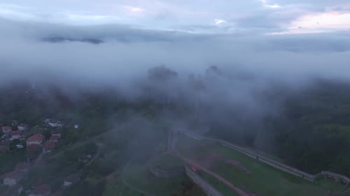 Aerial view of Belogradchik Fortress in misty valley, Bulgaria.