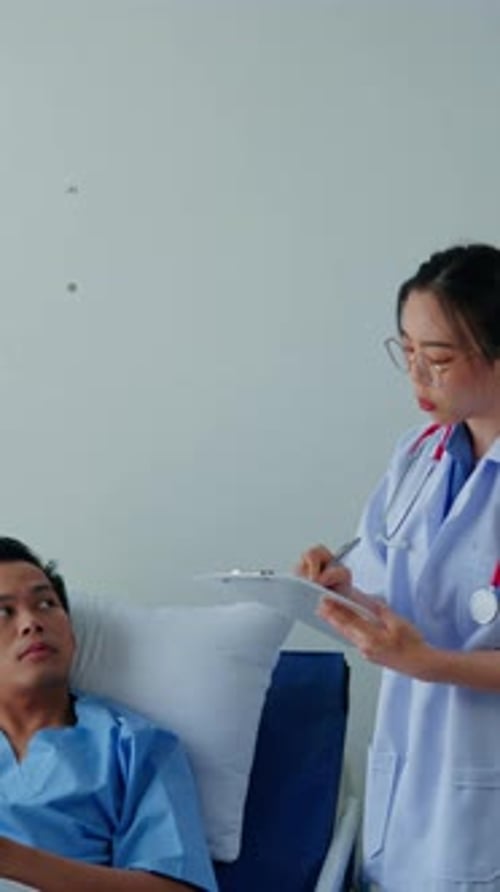 Vertical footage of Doctor examining patient in hospital.